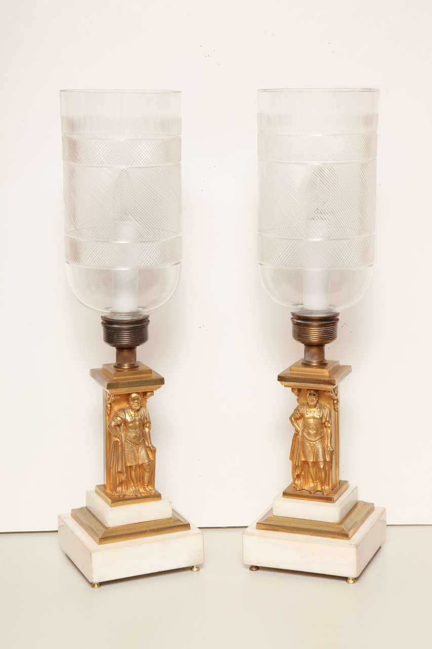 A pair of 1840s neoclassical lamps by Christopher Cornelius of Philadelphia, with gilt bronze supports in the form of Roman generals on marble bases. The lamps were refitted with cut-glass shades in the mid-20th century.