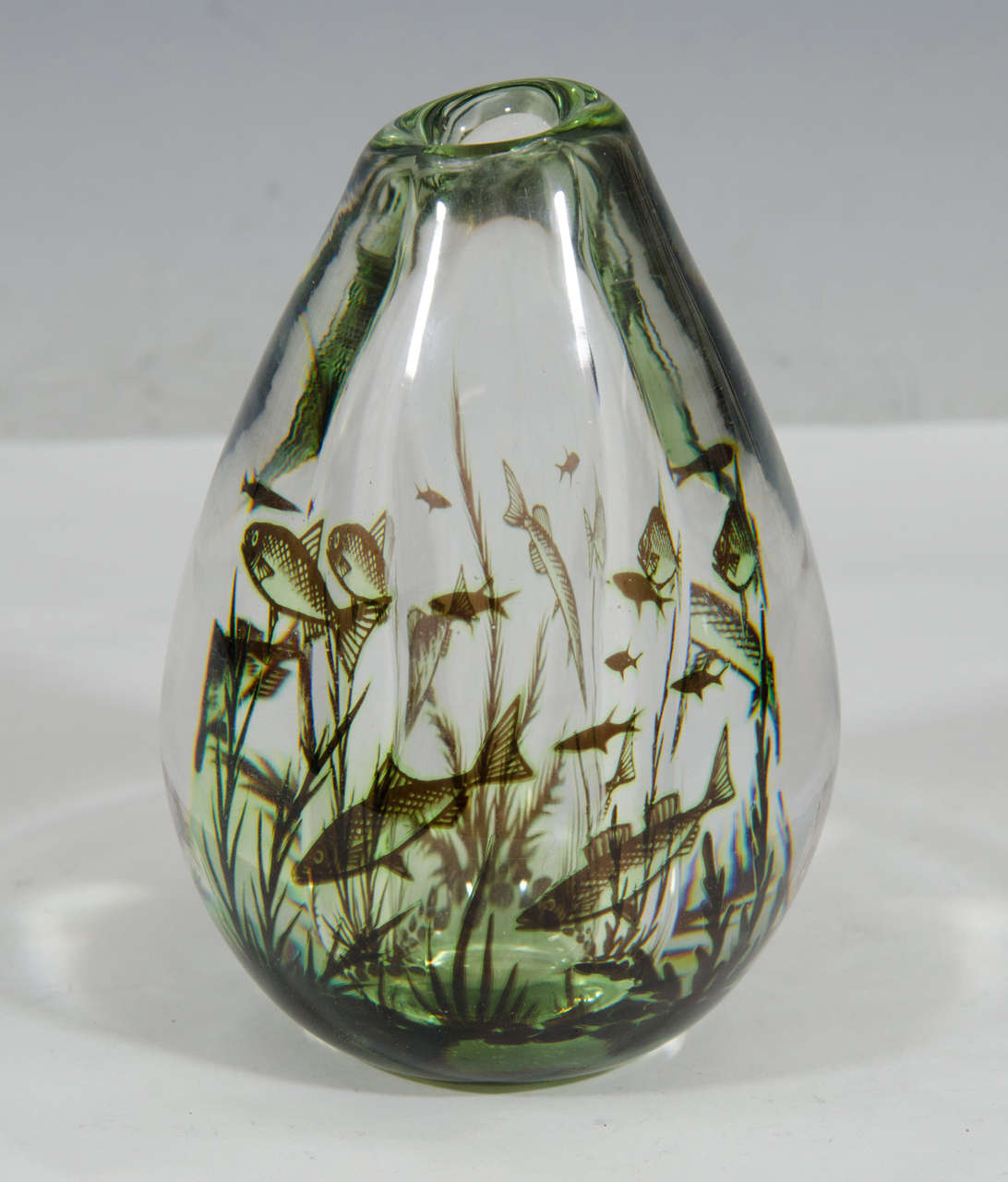 A vintage heavy crystal art glass vase in Graal technique with inner decoration of fish and seaweed. Signed on bottom: Graal No 478N by Edward Hald for Orrefors.