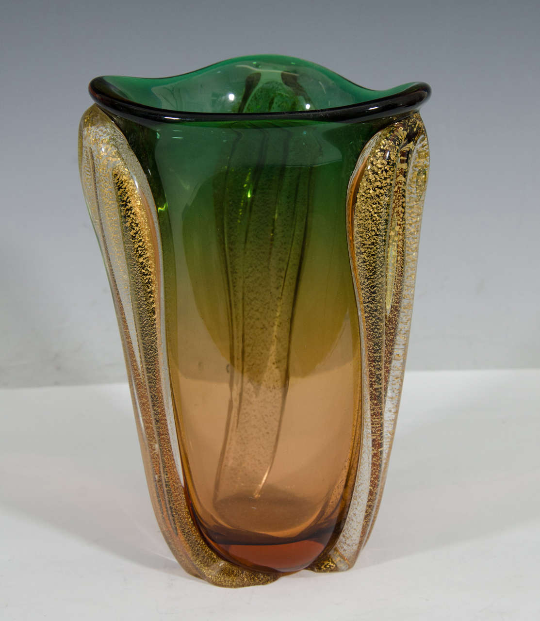 A vintage Murano glass pointed vase, produced in Italy circa 1950's - 1960's, in ombre green and amber, infused with flecks of gold leaf. Very good vintage condition, consistent with age and use, small chip on the base.