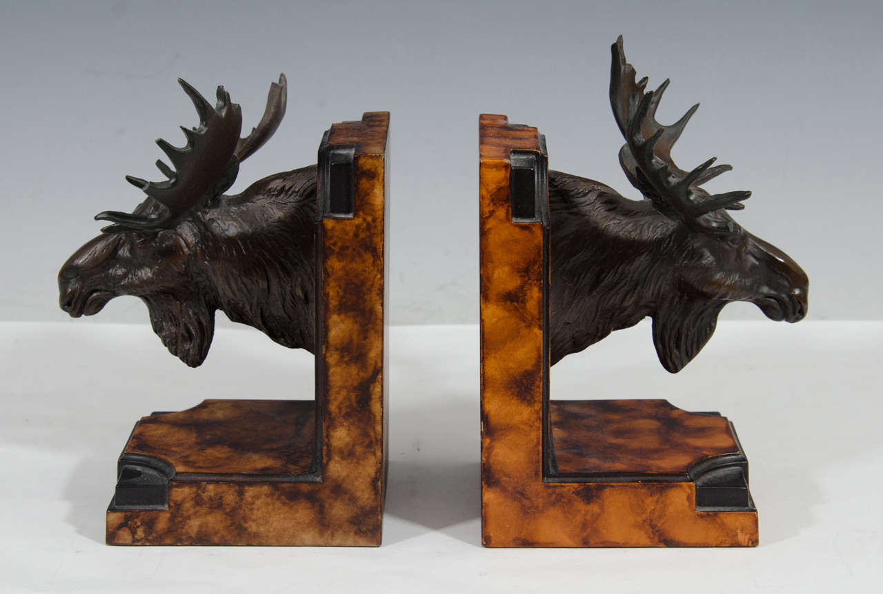 A pair of bookends comprised of moose heads with large antlers. Good condition, consistent with age and use. One antler has been repaired. There are also nicks and wear to other antlers.

Reduced From: $550