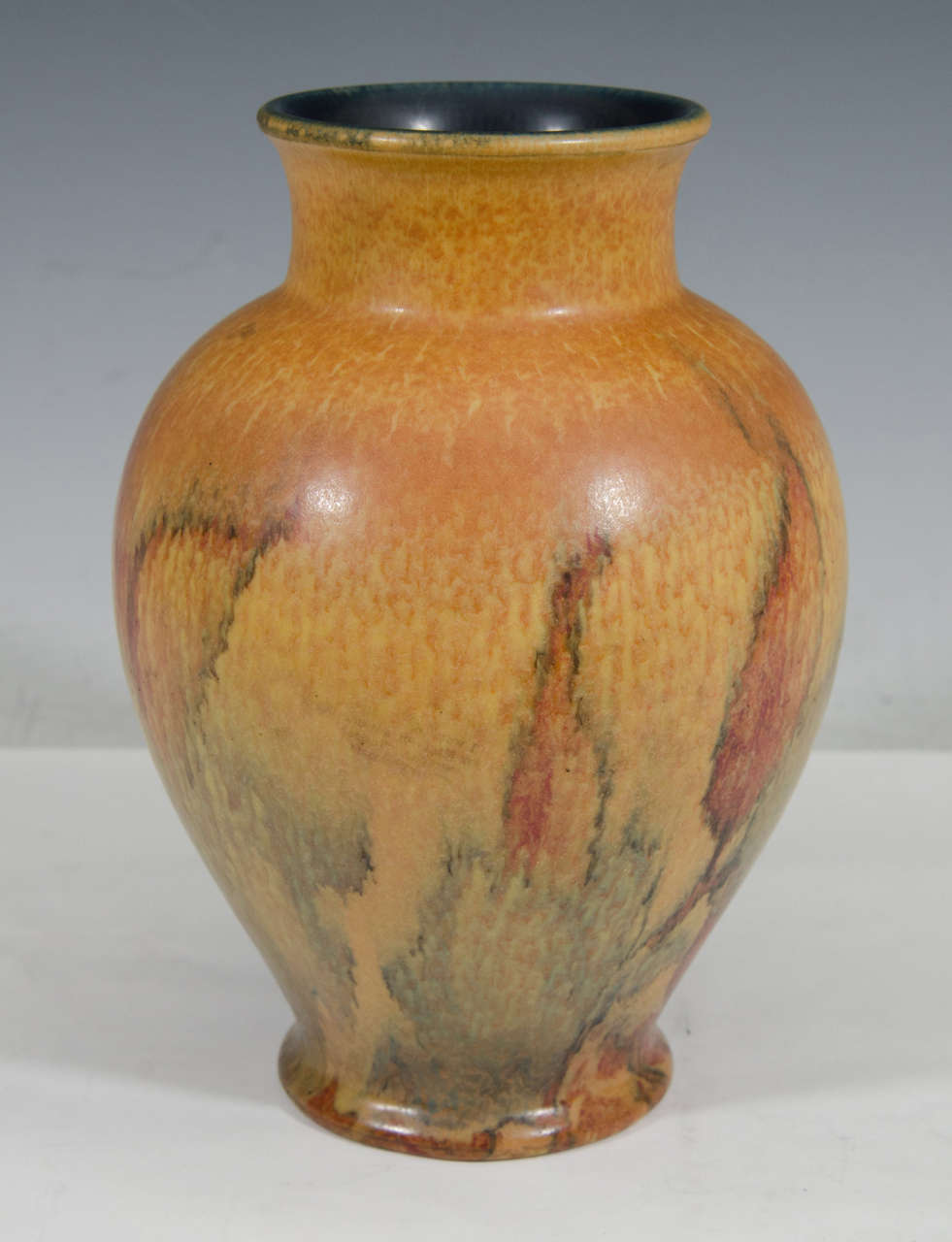 A Rookwood wax matte pottery vase in orange, yellow and red by Katherine Jones. Stamped on the bottom 2746, XXIX, and initials KJ. Markings can be verified in 