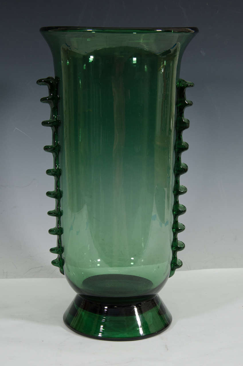 A vintage deep green Italian glass vase inspired by Napoleone Martinuzzi with textured glass ridges along the sides. Good vintage condition with some glass bubbles.