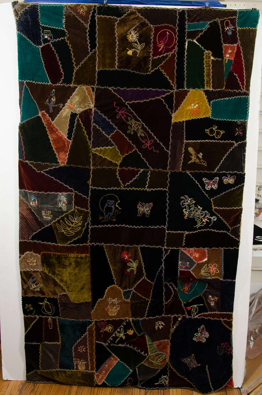 A 19th century multi-color handmade Crazy quilt in velvet with embroidered flowers, birds, butterflies, and baskets.