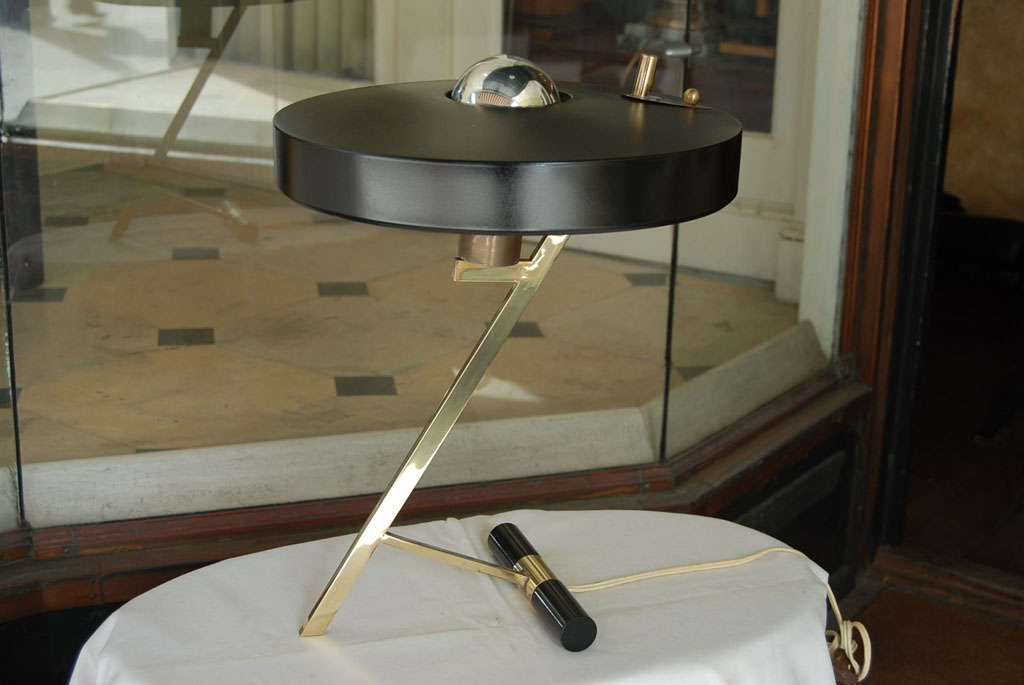 This table lamp manufactured by Phillips and designed by Louis Kalff shows all the elements most prized in the modern movement. The design a stylish reduction of form and function has married good materials and great design to the mass production