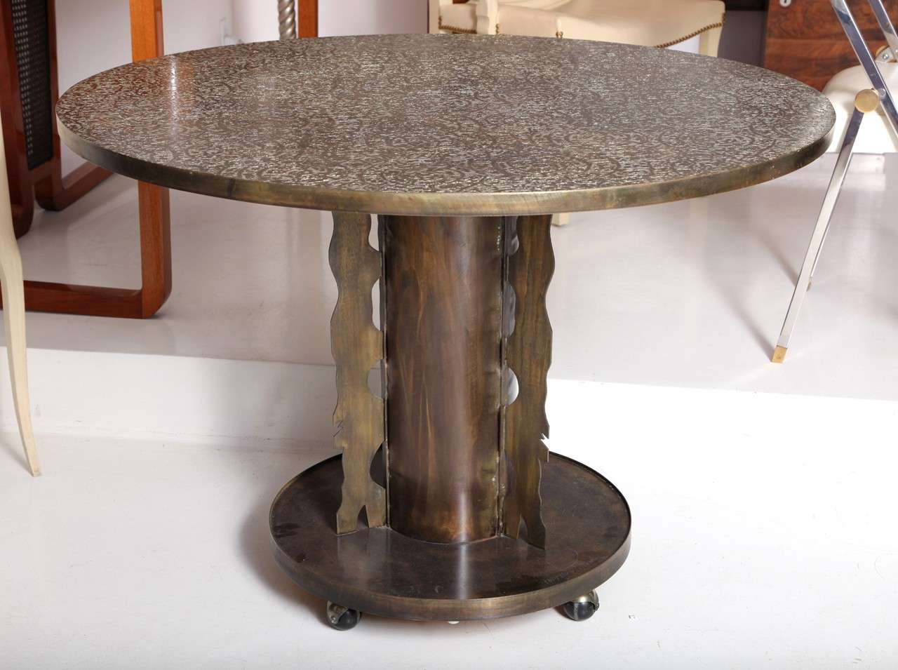PHILIP (1908-1988) and KELVIN (b. 1936) LAVERNE
Center table with Etruscan motif decorated top raised on
pedestal base with cutout flange details, on casters.
Signed.
American, c. 1960

