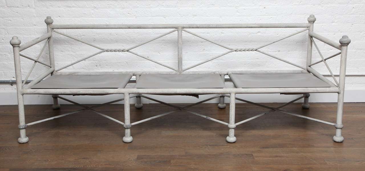 A Neo-classical pair of garden benches with a flat smokey grey patina, X sides and backs with ample room for cushions and pillows.
There is a strong stretch of outdoor canvas to support seating.
 