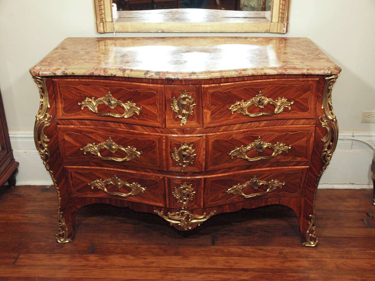 This commode makes one realize the excellence in craftsmanship that many of the French woodworkers possessed. Kingwood, violet wood and rosewood comprise the inlays. The marble top is in excellent condition. A truly marvellous antique.