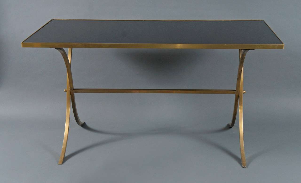 Brass coffee table with black top.