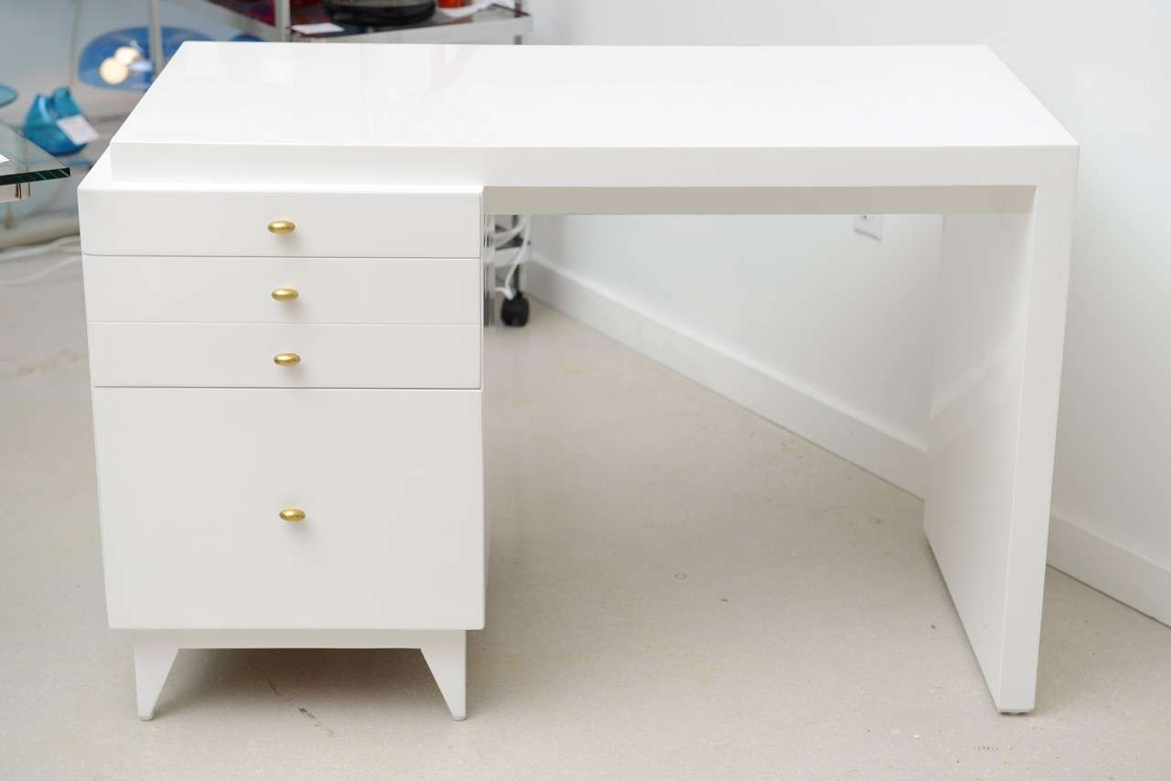 Vintage Mid Century modern white lacquer desk with four drawers. Compact in scale and classic in profile - the desk may be used in various settings.