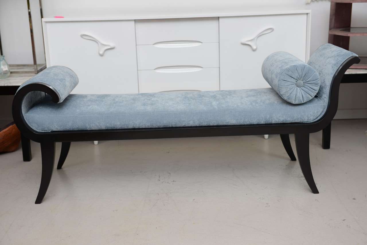 Scrolling vintage chaise with black legs and newly upholstered in blue cotton fabric.