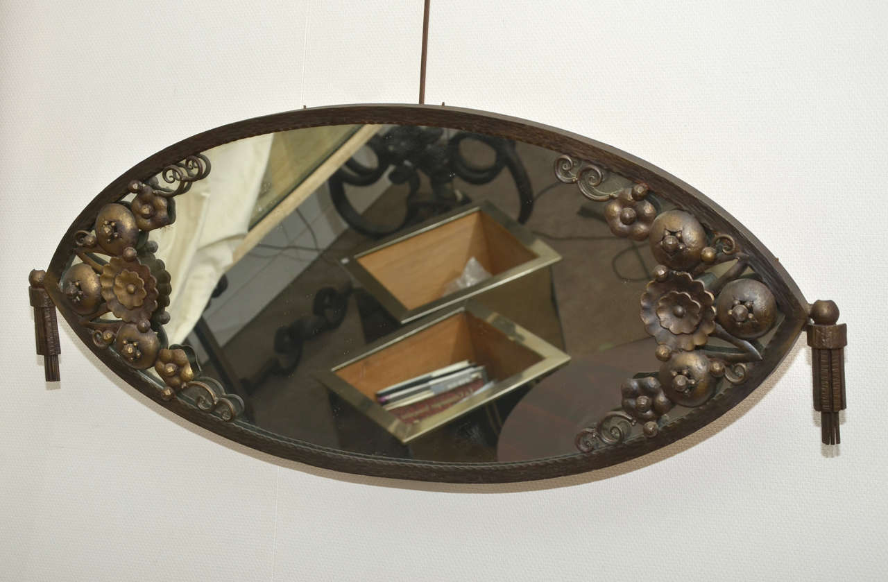 1920s original mirror with frame in wrought iron decorated with stylized flowers.