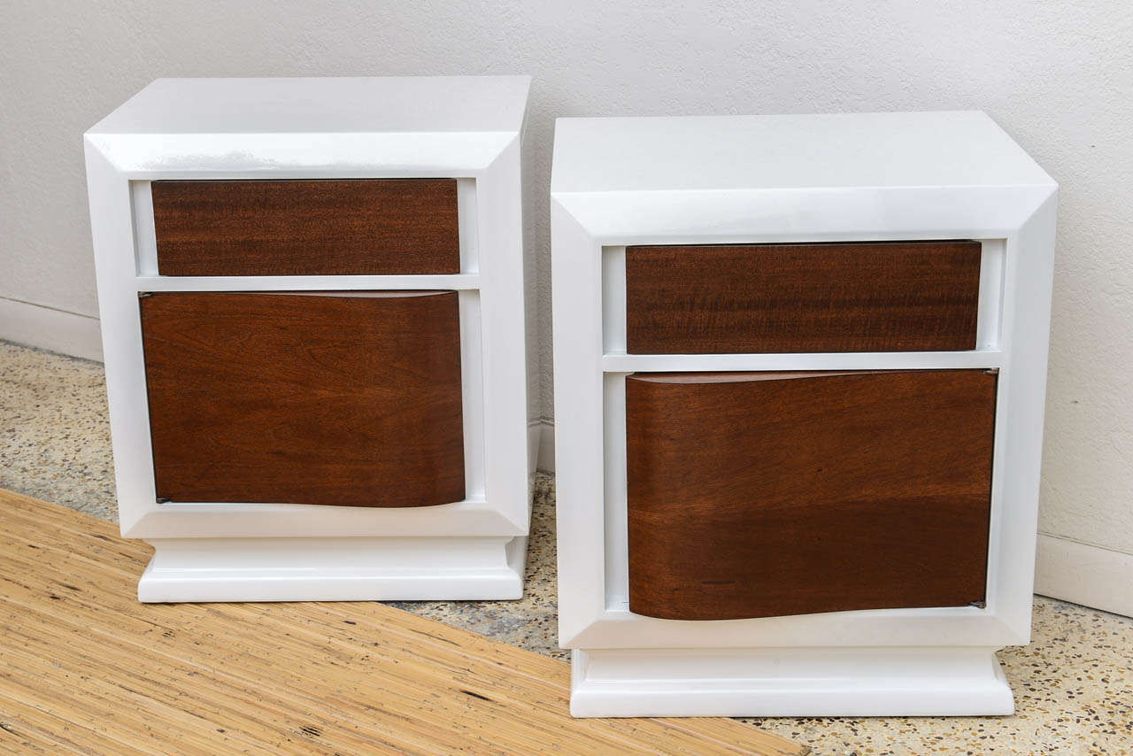 Stunning pair of Mid Century lacquered night stands with mahogany wood drawer and door details.

Please feel free to contact us directly for a shipping quote or any additional information by clicking 