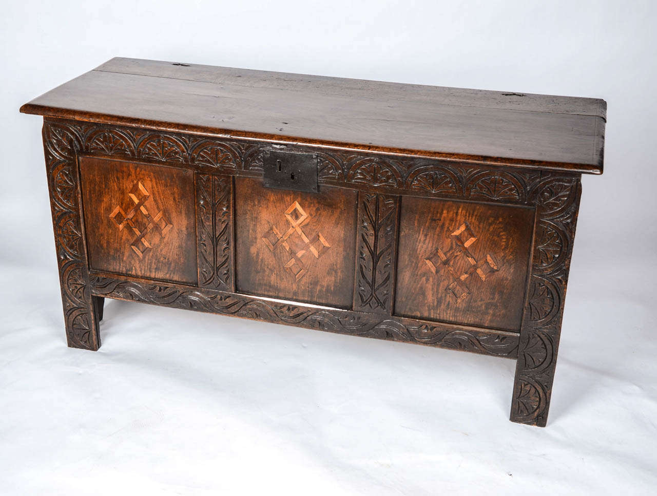 This is a good example of a Boarded OAK Chest or COFFER from the mid 17th Century or earlier,  with three superb front panels having Parquetry inlay of Holly and fruitwood. The inlay has a formal geometric pattern in the form of a celtic interface (