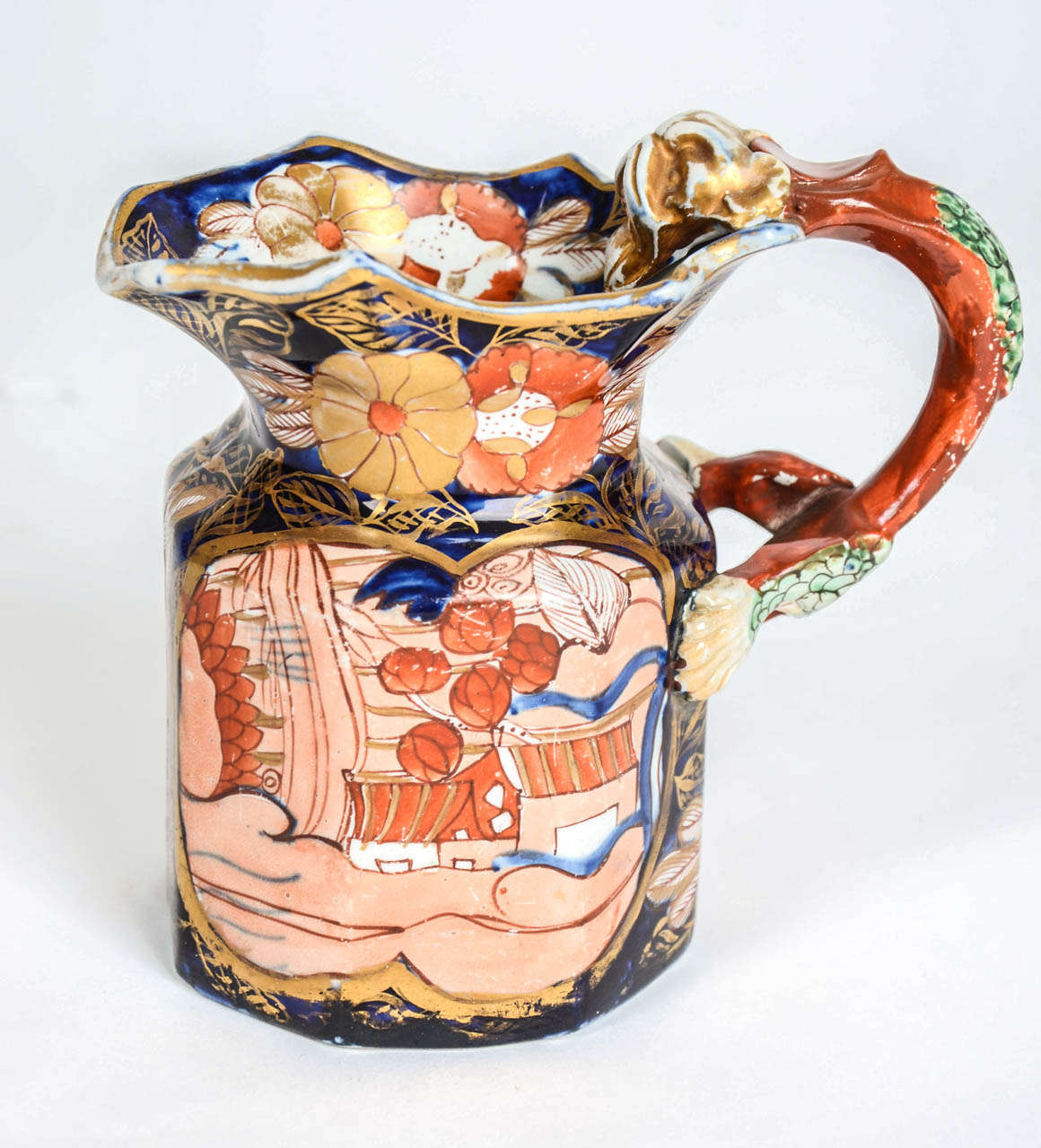 This is a fine and Rare Ironstone China Jug in the Fenton Shape made by MASON'S, of Lane Delph, Staffordshire, England

The jug is hexagonal with a dragon loop handle. The piece is profusely and  richly hand- decorated with bold enamels of cobalt