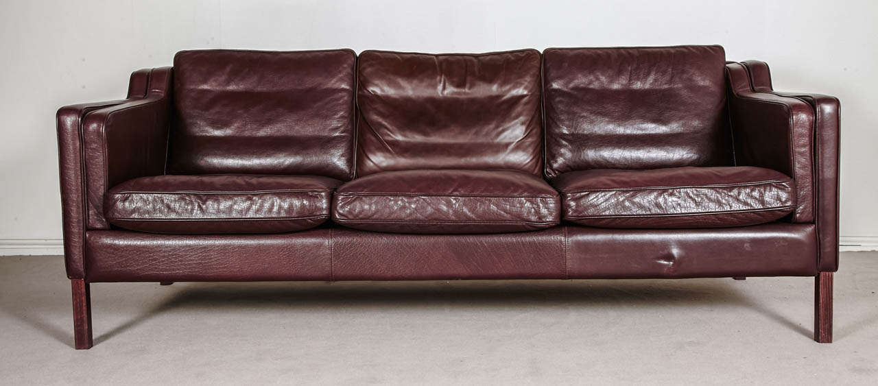 Tan leather three seats Danish sofa.