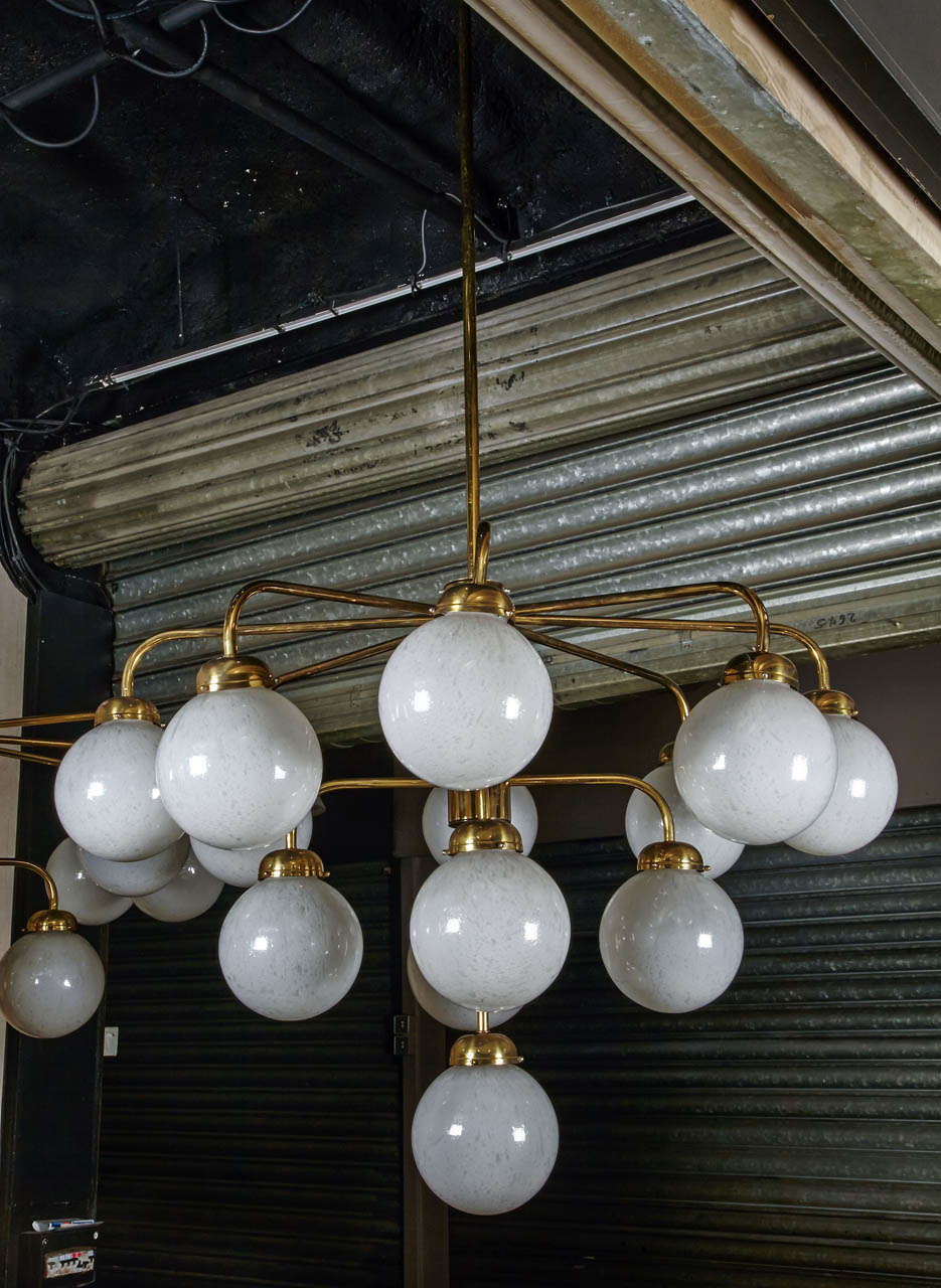 Pair of 1960's gilded brass chandelier with 13 lighted arms and opalescent bubbled glass spheres.