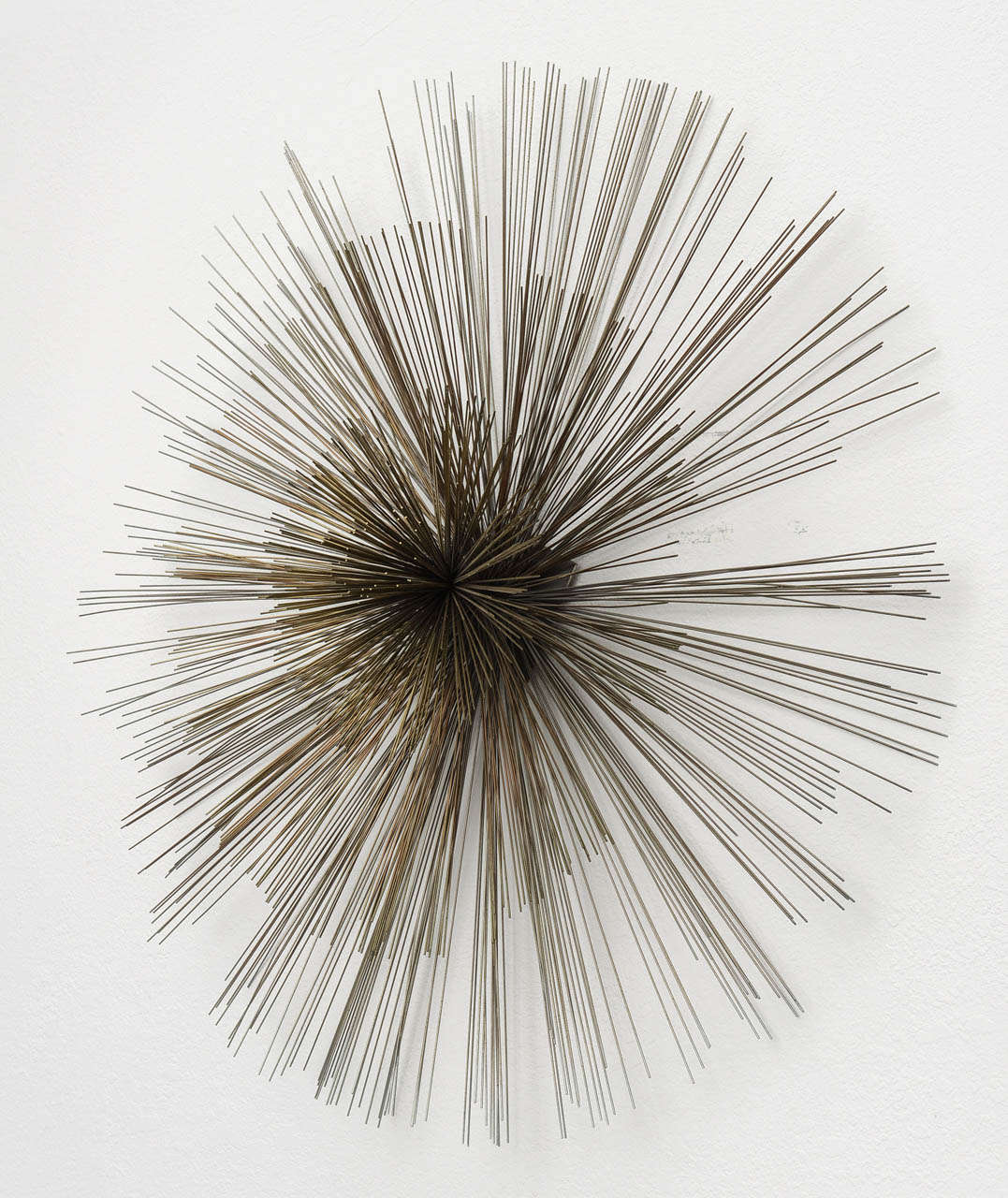 Fantastic large wall sculpture comprised of three tiers of brass spokes. Center protrudes 10 (ten) inches from wall. 