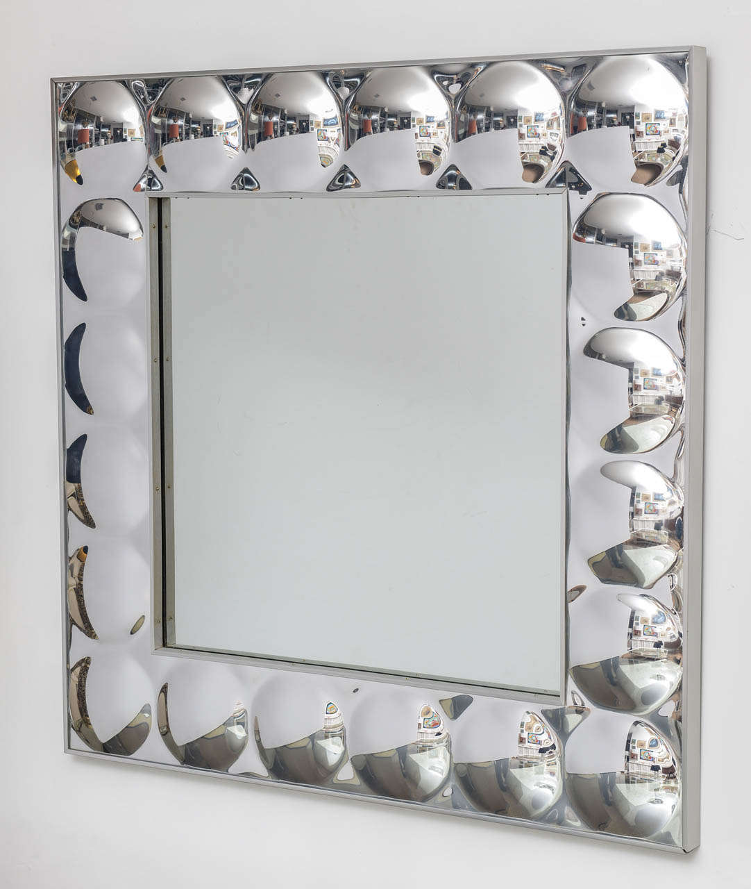 Square mirror with silver acrylic bubble surround followed by a brushed aluminum exterior frame.