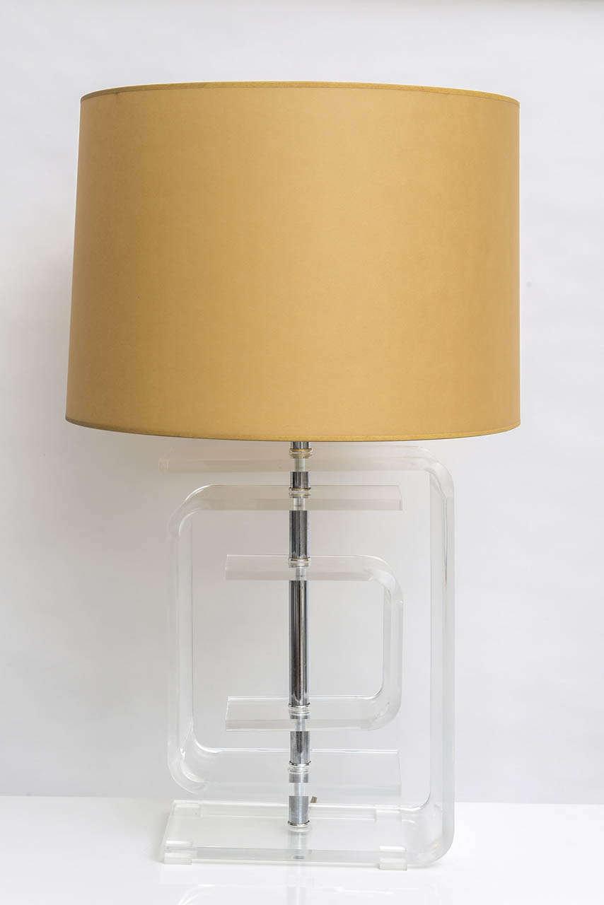Lucite table lamp comprised of three varying sized Lucite U-shaped components centered around chrome rod.
Measurements are to top of finial.