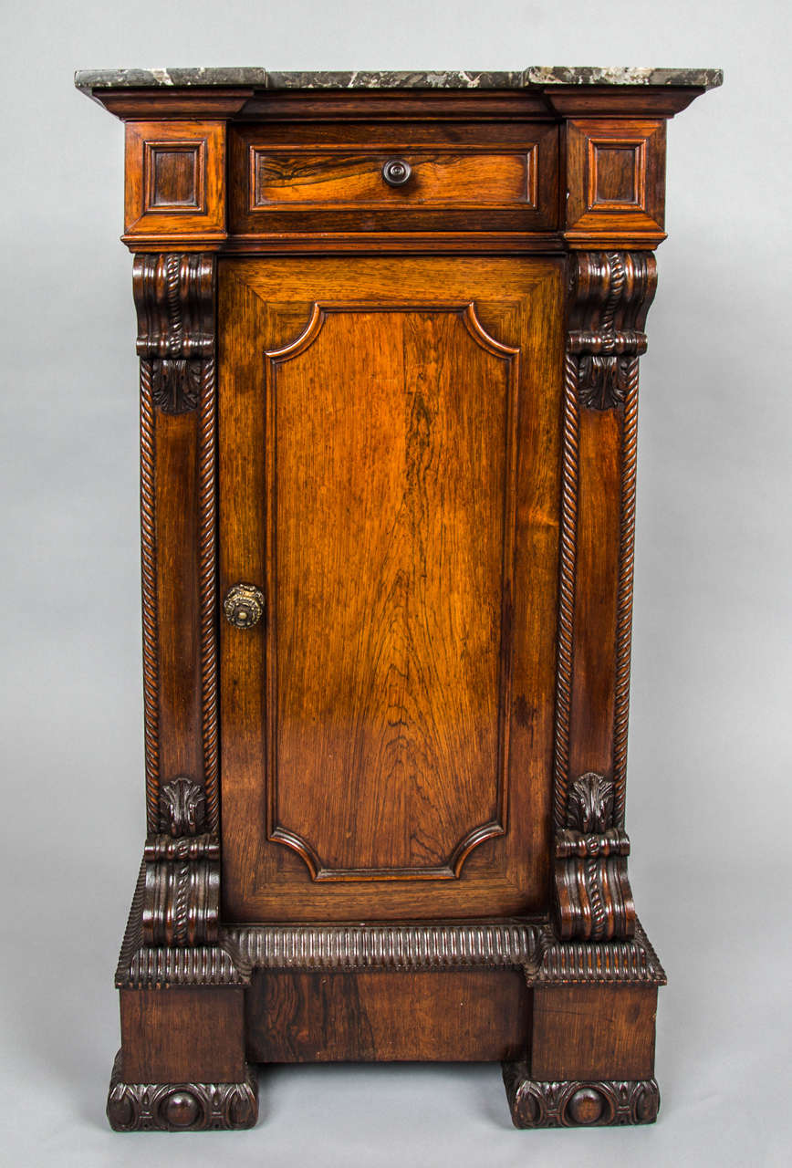 A pretty William IV rosewood bedside cabinet with marble top frieze drawer and cupboard.