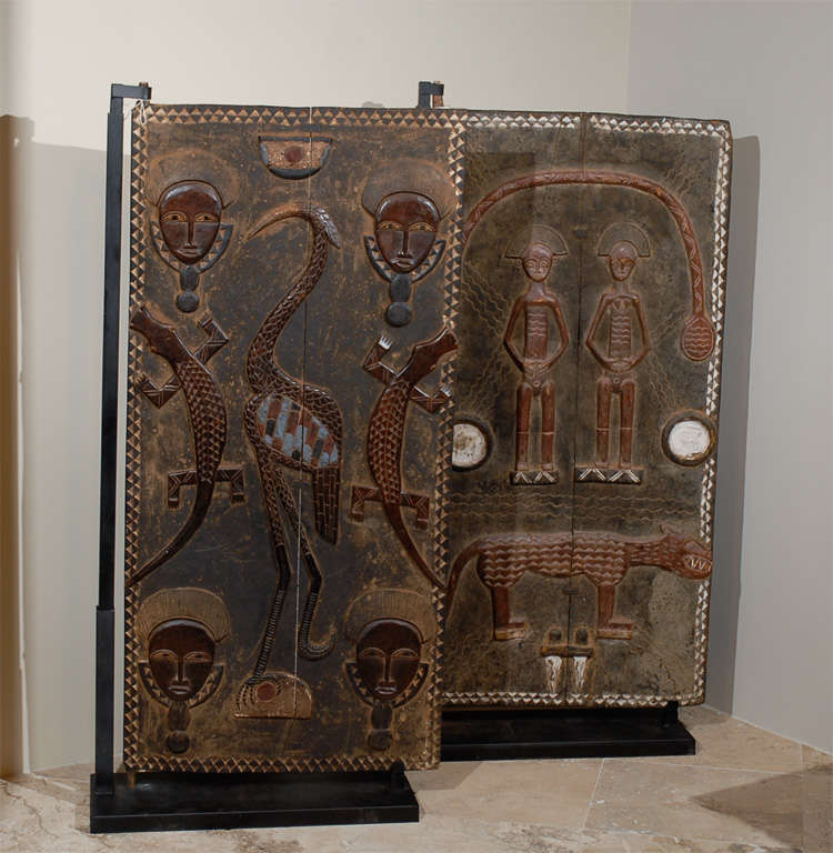 Ivory Coast grainery door with four figures, bird and reptiles.