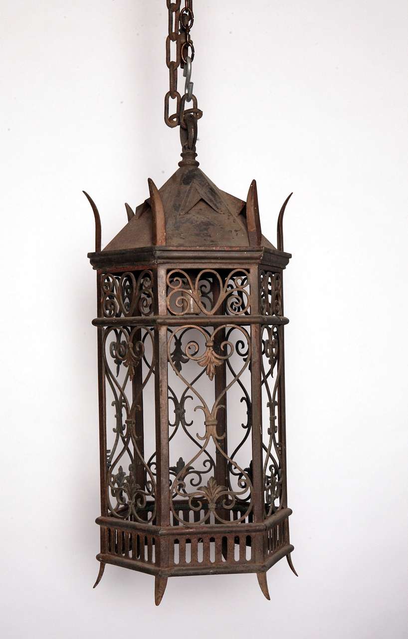 1920's hexagonal iron lantern, with bronze scrollwork panels.  Needs to be rewired, and can have glass added.