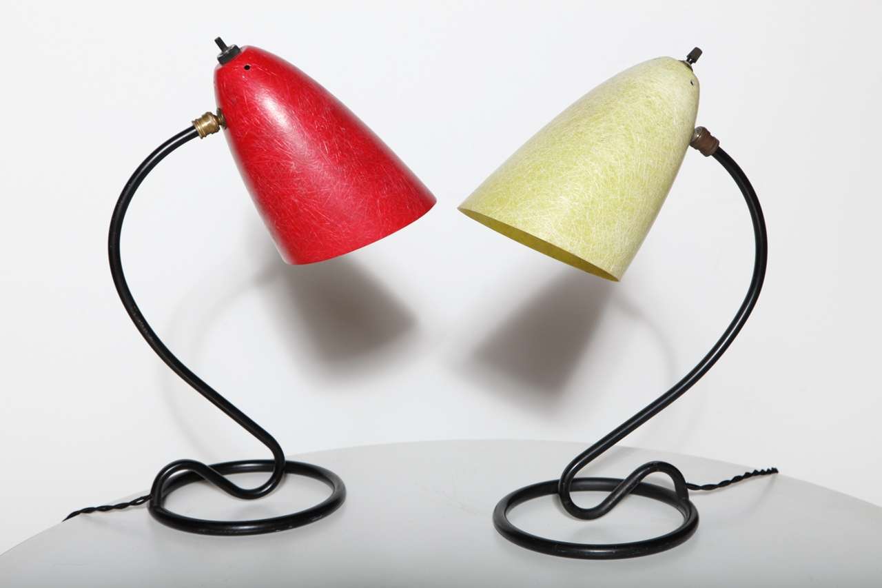 Kurt Versen loop design Fiberglass Table Lamps produced by Kurt Versen Lamps Inc. Available individually. One lamp with pale yellow shade. Second lamp with red shade. Each lamp features original vented and adjustable cone fiberglass shade with black