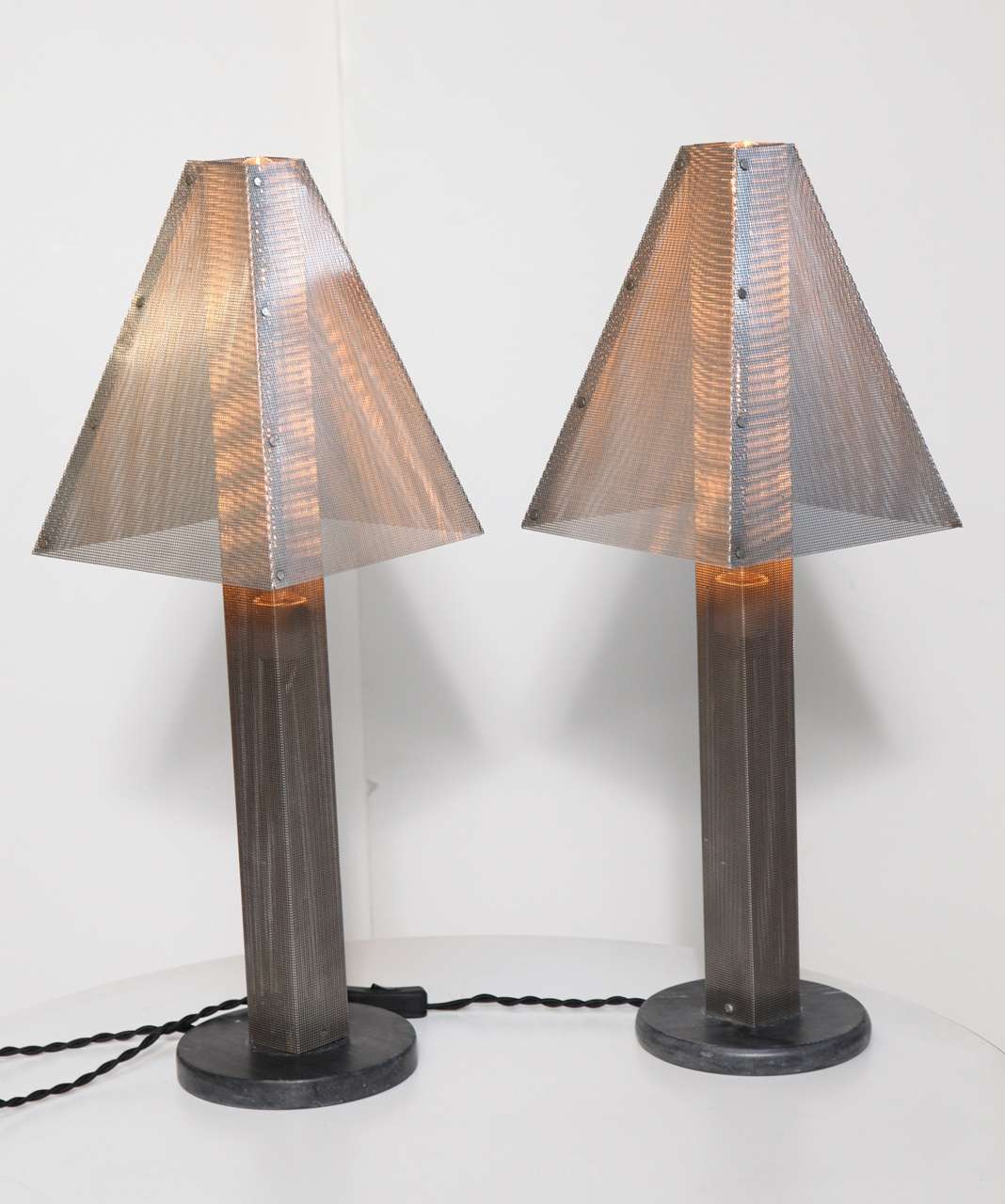 Pair of Post Modern Mesh and Marble Table Lamps by handbag designer, Wendy Stevens. Featuring a rectilinear fine Steel Wire mesh column and Shades, on round Dark Gray Marble bases. Architectural. Neutral. Statement lighting. Casts a beautiful warm