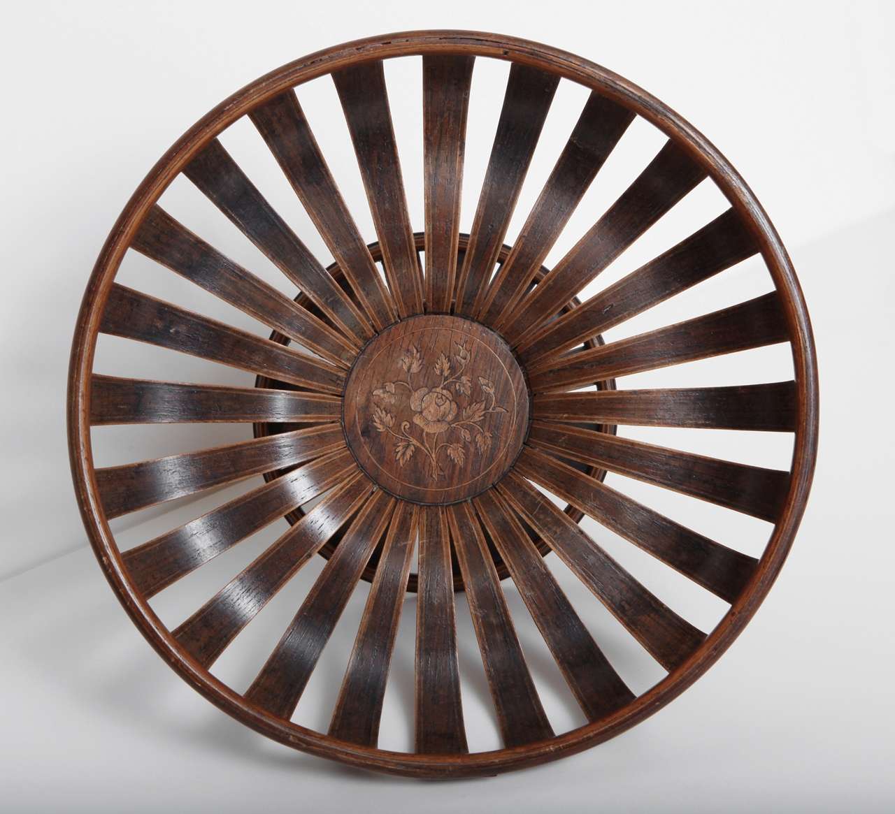 An unusual 19th century English bentwood fruit bowl
with pierced and shaped inlaid lathes