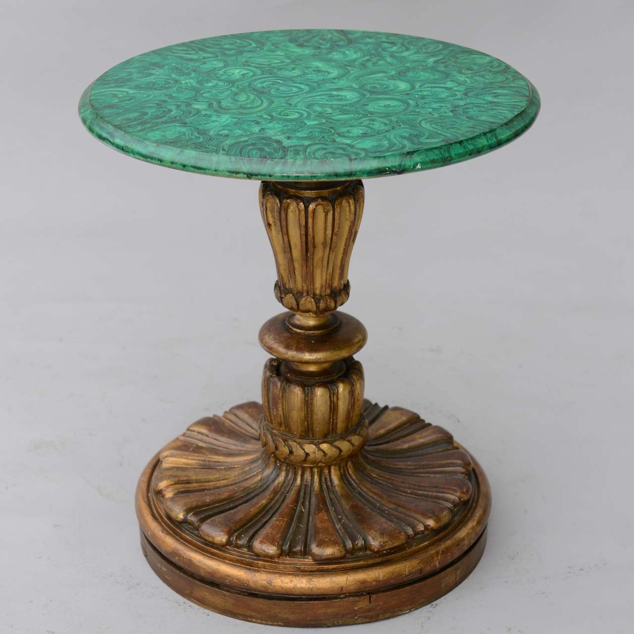 Round accent table, having a later faux painted malachite top, raised on giltwood pedestal with fluted column and round base.