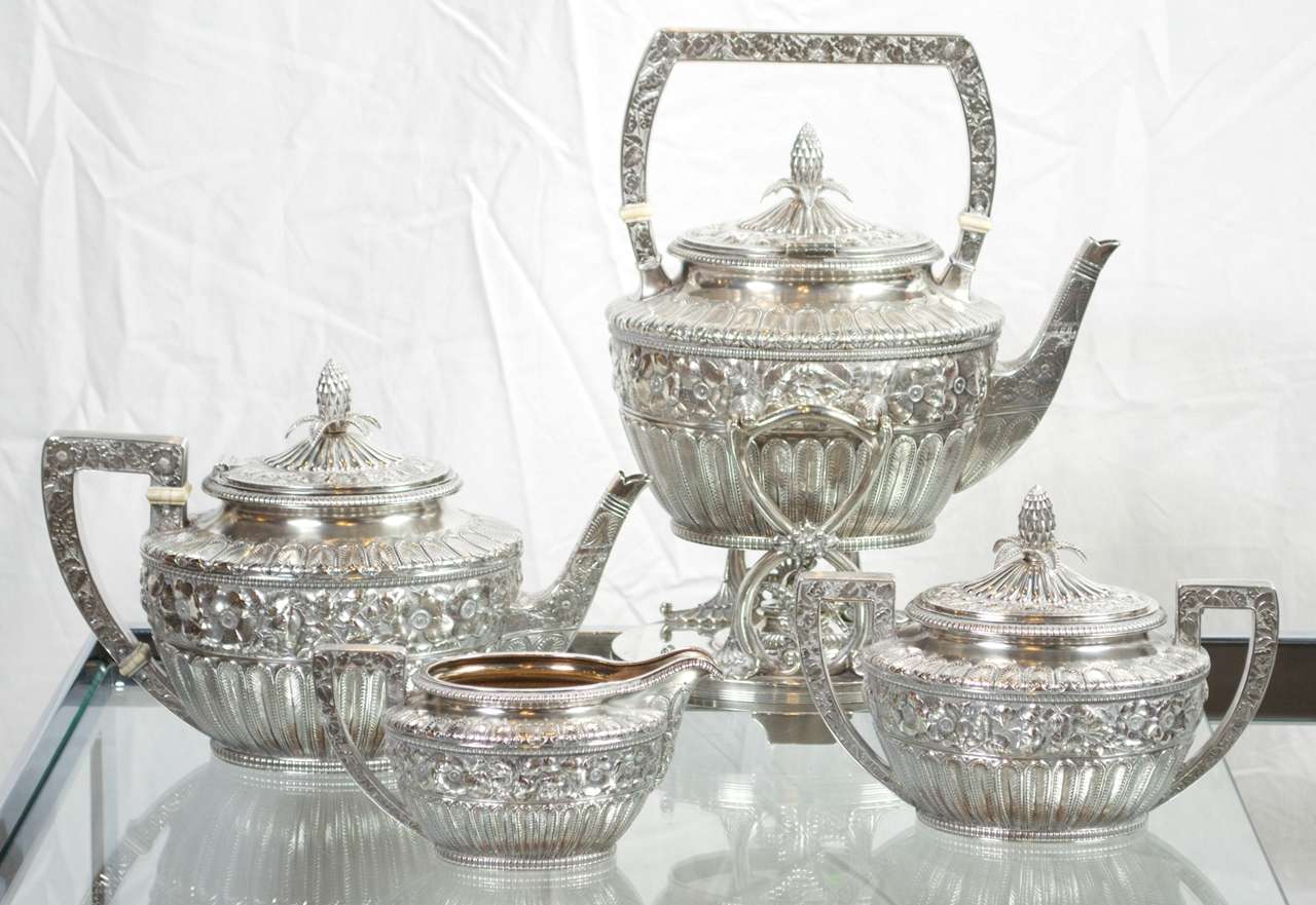 This exquisite sterling tea service is from the estate of a 105 year old whose grandmother had it custom made by Gorham in 1879.  The handle lid and sholder are emblished with biar roses flanked by feathers. The lid is accented with a finely