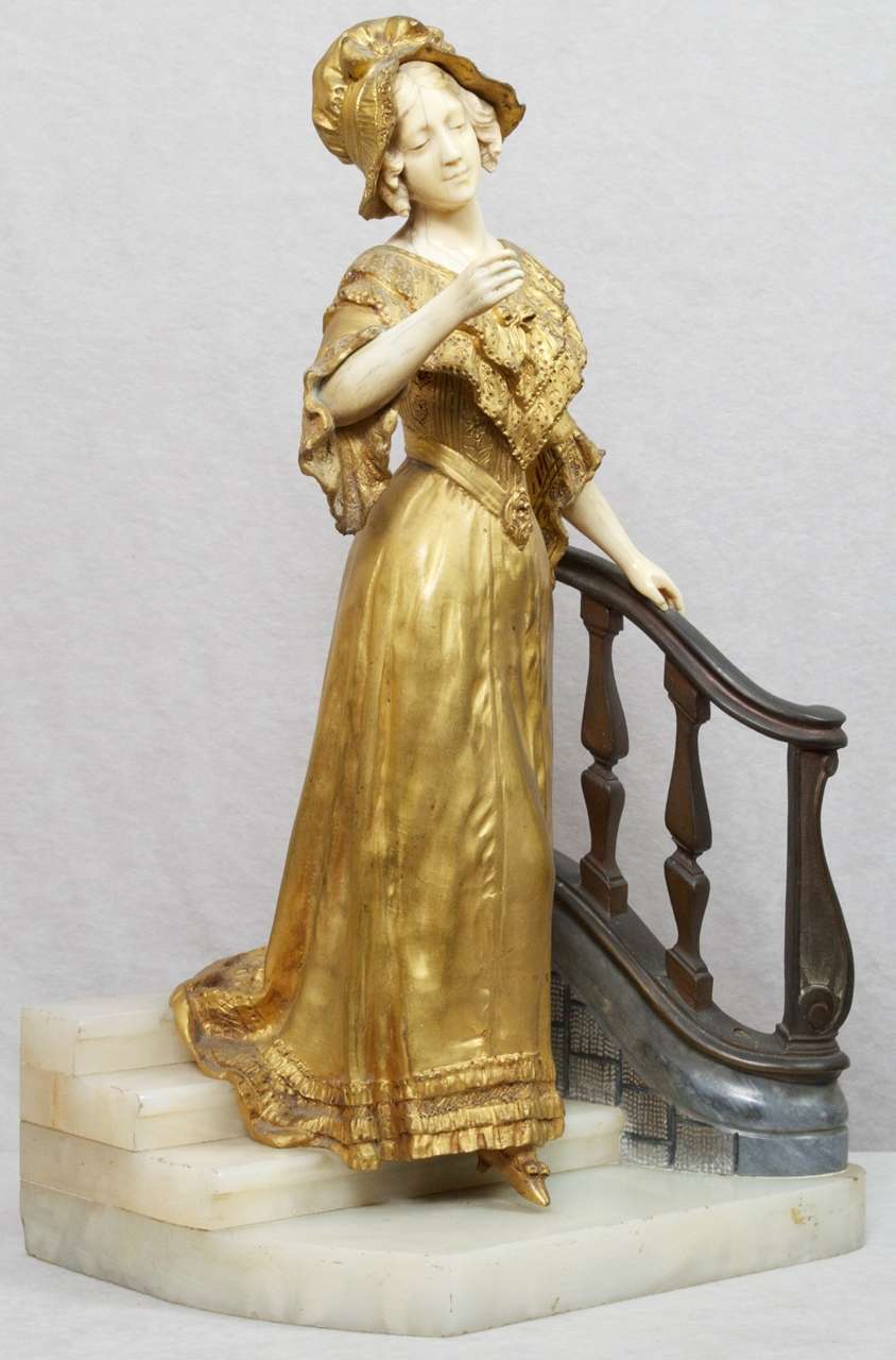 This very elegant statue by the noted artist Affortunado Gory is a fine example of his work.  The beautiful gilt woman is descending the staircase which consists of bronze and onyx.  An impressive and well defined sculpture.