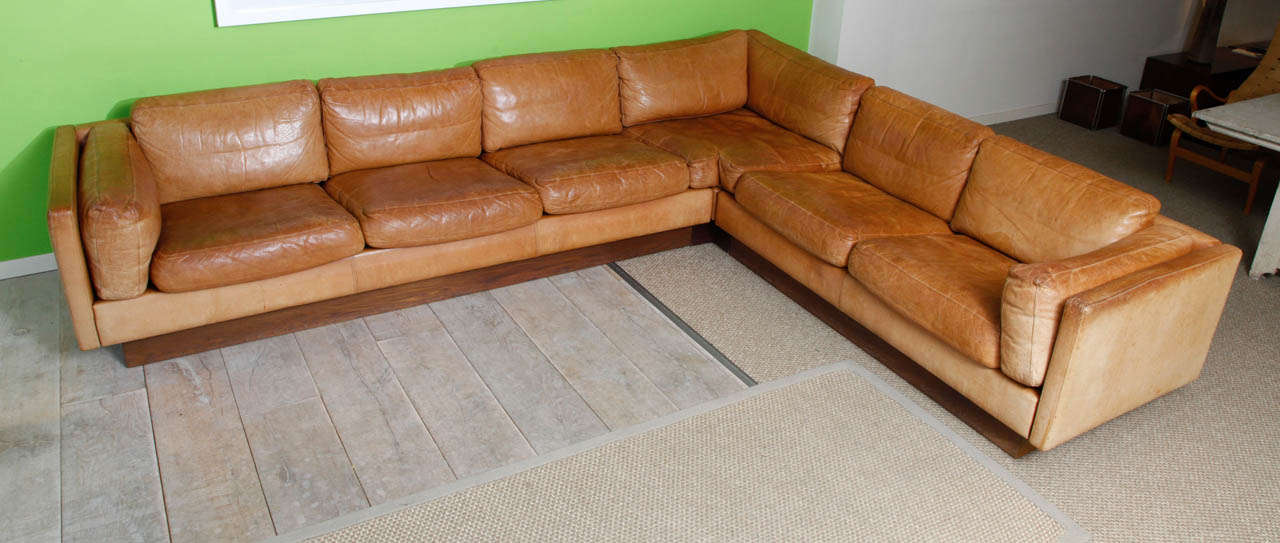 Corner sofa with beautiful cognac colour and patina.

the width of the two seat part including the corner is 245cm,