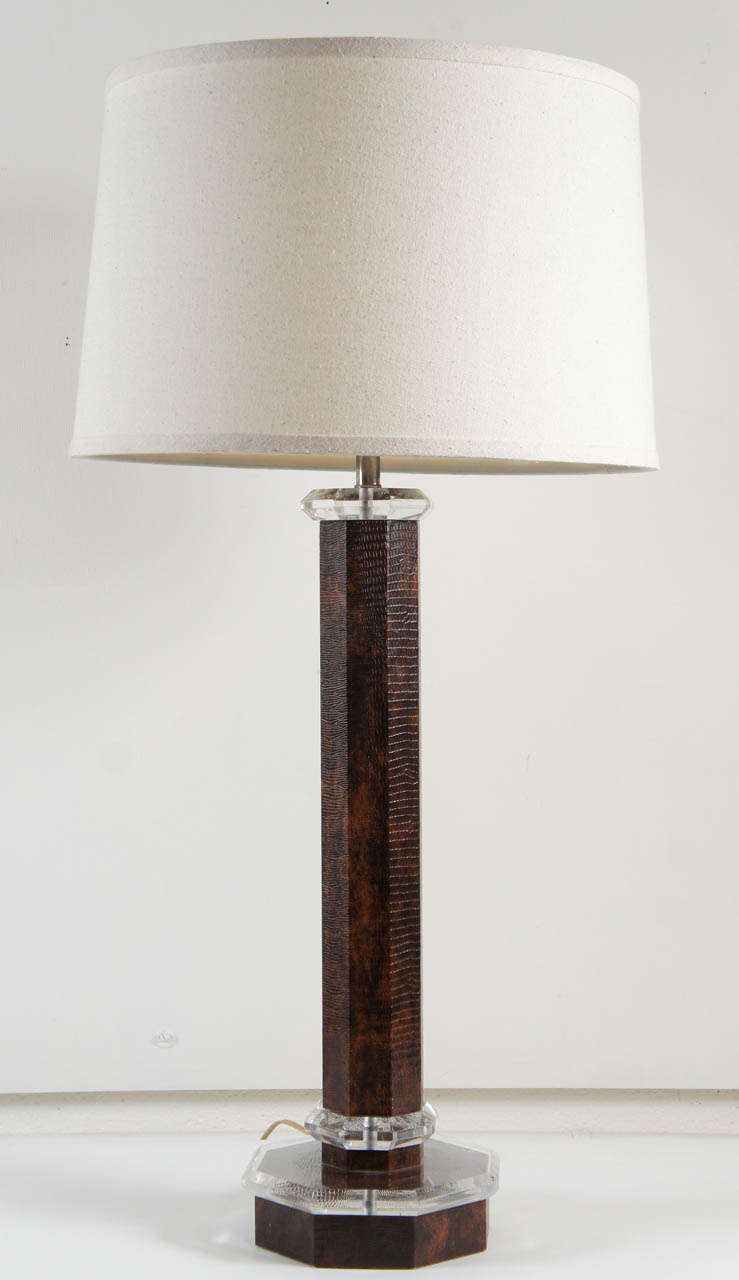 Here is a beautiful table lamp in the style of Karl Springer.
The lamp is made of a faux lizard in a tortoise color with lucite details and base.