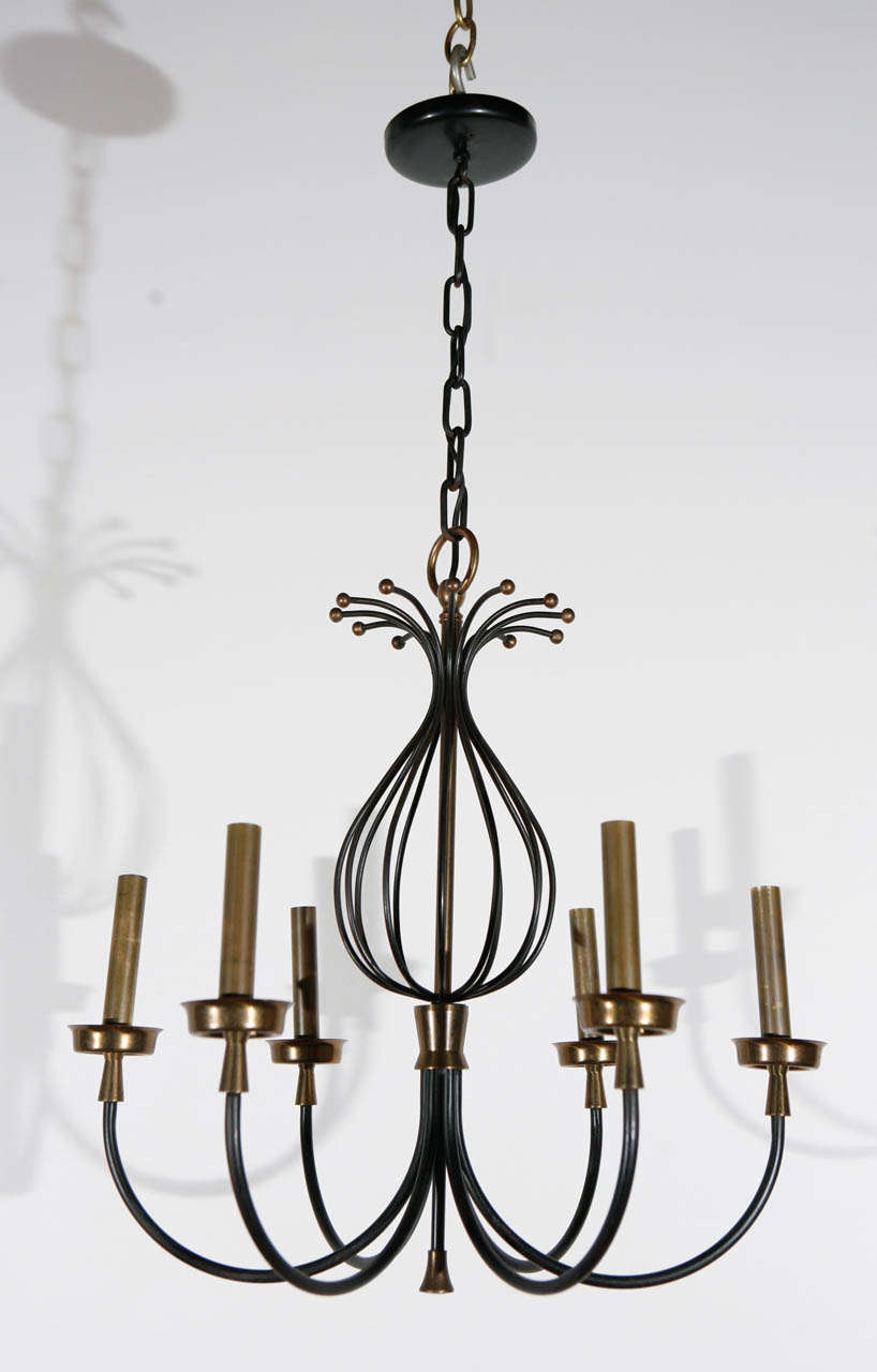 French chandelier with iron and brass details; newly rewired with six candelabra sockets, each sockets can take a 75 watt bulb.