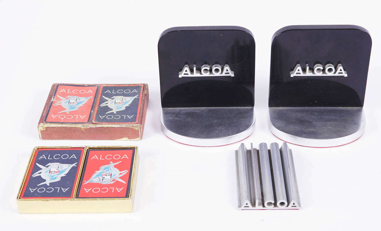 Fun set of vintage 1950's Alcoa advertising pieces.
Bookends have chunky vitrolite backs, with applied name-plate trim from extruded piece and solid aluminum bases, felt underlining.
Extruded aluminum paper weight has slide-out laminate with