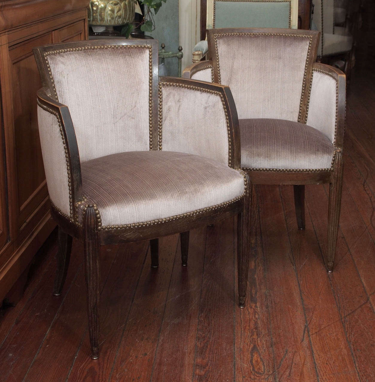 Pair of  walnut Art Deco bergeres newly reupholstered in taupe velvet fabric.