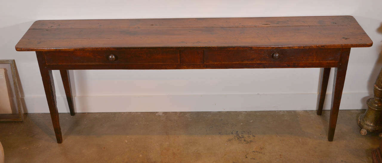 19th c. French Fruitwood Server with two drawers and tapered. legs.  Probably  converted from a larger table to meet the demand today for servers or sofa tables.  Beautiful patina.