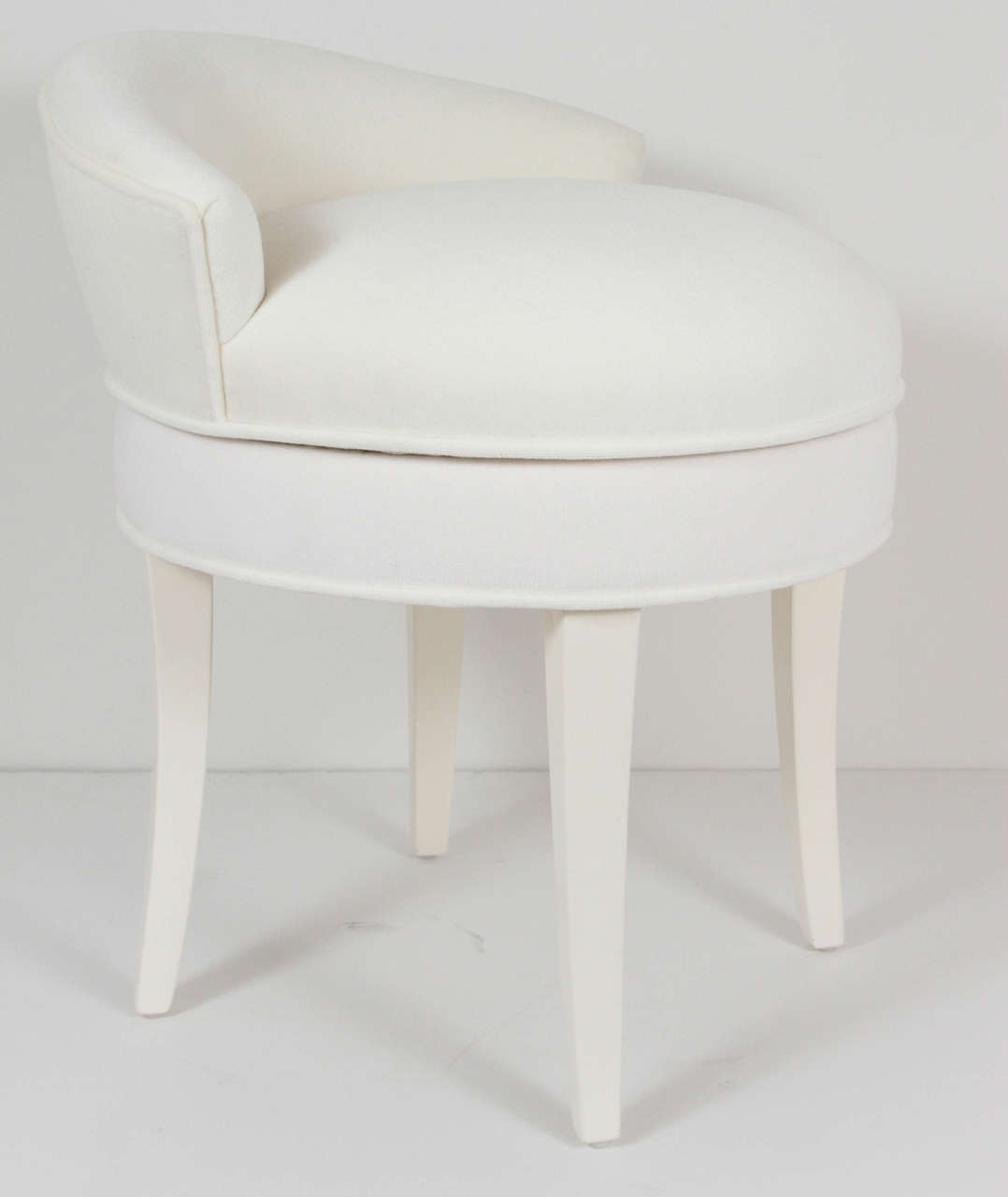 Vintage Samuel Marx upholstered swiveling vanity stool, recently reupholstered in an off-white velvet, circa 1954.