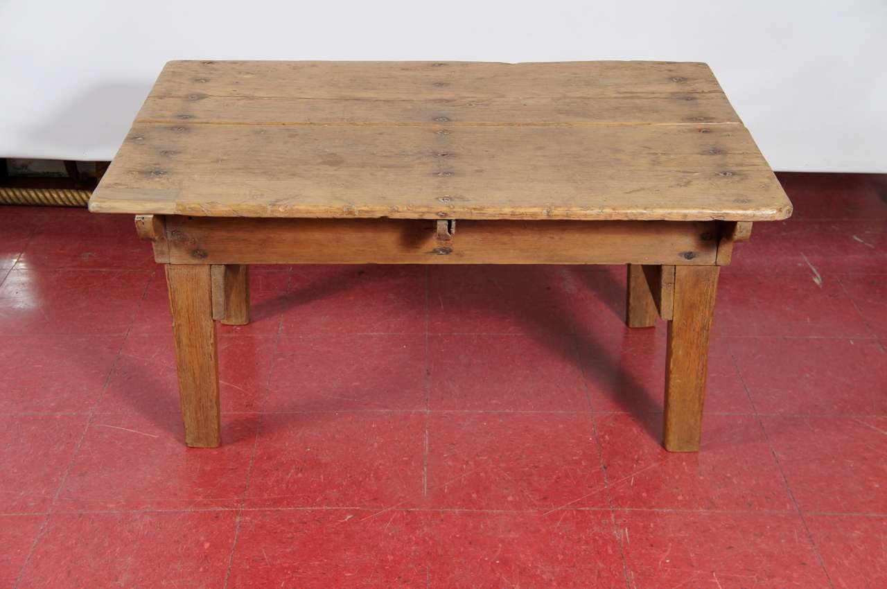 Rustic antique French coffee table has  bracketed apron, solid tapered legs, securely fastened joints, tongue-and-groove boards,  Great character.