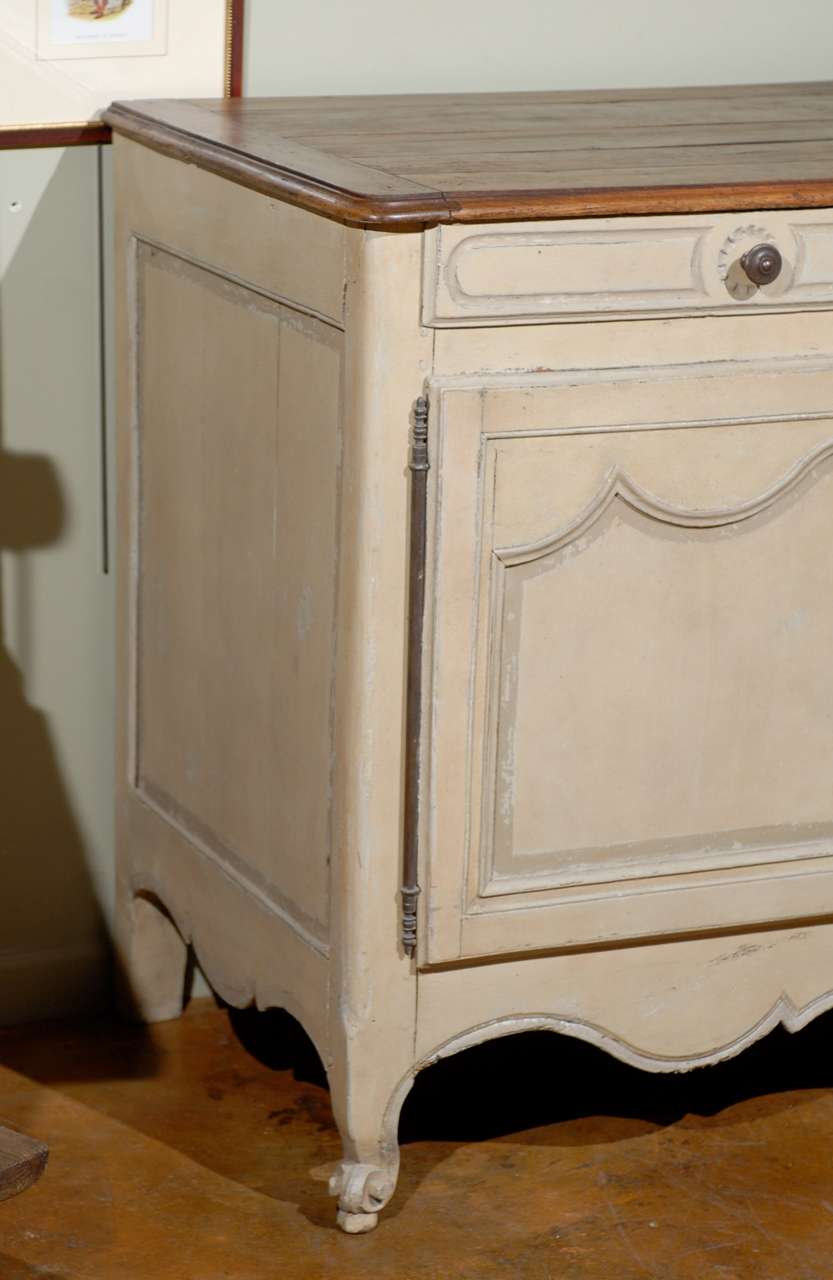 19th century French Provincial paint decorated buffet, the natural rectangular top surmounting two short drawers and a double door cabinet opening to reveal two shelves, raised on scrolled short feet. 