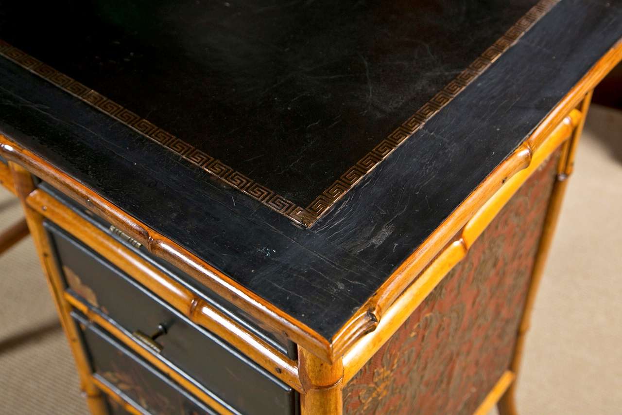 Made in 1890 this black leather top desk with five drawers and
original hardware. Bamboo was send from English colonies to Leeds
England for manufacture. The drawers are black lacquer with
chinoiserie designs. Finished back and sides- Mahogany