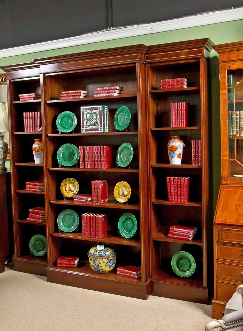 Made in England this Mahogany bookcase has satinwood inlay;
It is made in five sections- Adjustable shelved are done with 
ratcheted side supports. Center section is 16