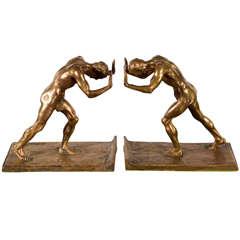 Pareja de sujetalibros figurativos de bronce dorado