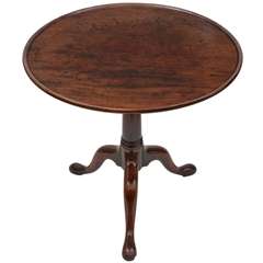 A Fine George II period mahogany dished top tea table on gun barrel stem