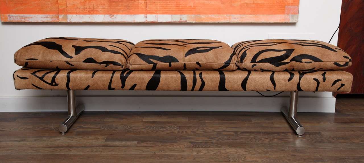 A Milo Baughman three cushion bench upholstered in tiger hair on with chrome legs.