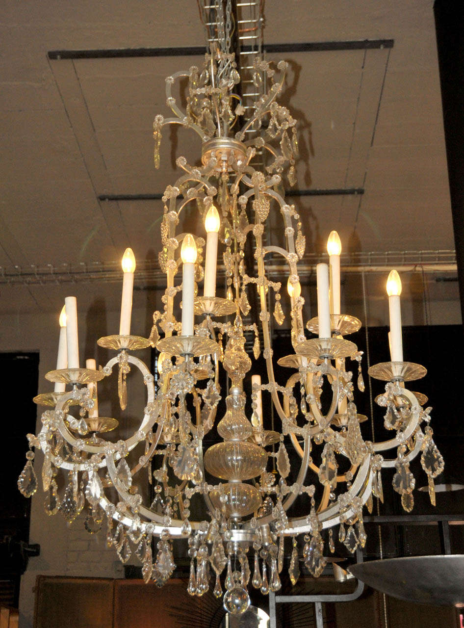 Pair of 1960's cristal and silvered metal chandeliers. Sixteen ligths per chandelier. Wired for European use.  Good condition. Normal wear consistent with age and use.