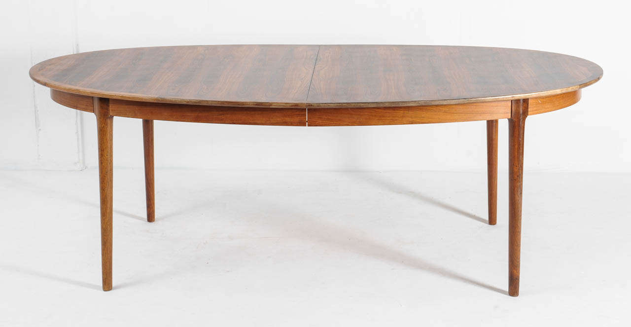 Breathtakingly beautiful and extremely rare set of rosewood table and matching 8 chairs (see other listing) by Norway's top designer Torbjorn Afdal made in the 1950's for manufacturer Bruksbo Tegnekontor. The table has a sliding mechanism with which