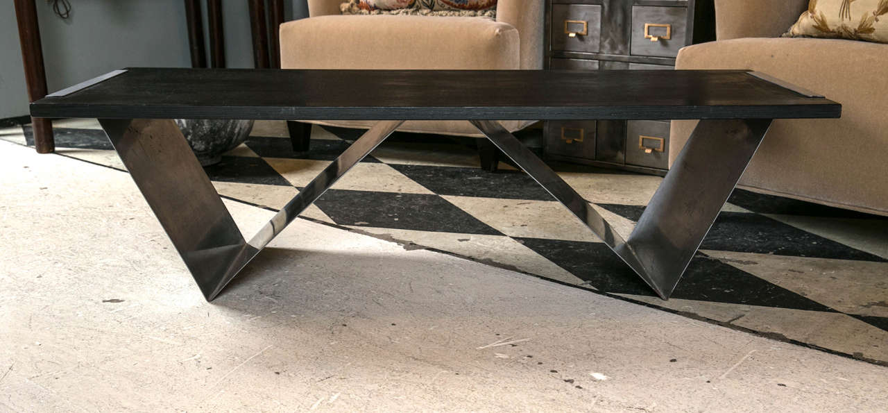 Modern geometric style wood and steel coffee table.  This table can also store your magazines.