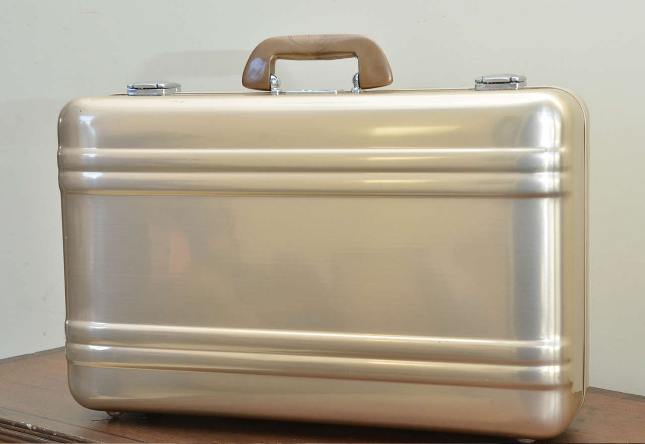 Halliburton 1970s rare gold toned alumnium suitcase (never used) Zero Halliburton label reg. Z 128503 with registration card and warranty information. Contains zippered clear plastic lined cloth bag (14